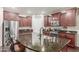 A well-equipped kitchen with a large island, stainless steel appliances, and dark wood cabinetry at 10811 W Avenida Del Rey --, Peoria, AZ 85383
