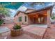 Serene backyard featuring mature landscape, and a covered patio with decorative string lights at 10811 W Avenida Del Rey --, Peoria, AZ 85383