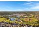 Expansive aerial view captures the neighborhood with its community park and baseball fields on a clear, sunny day at 1120 E Harbor View Dr, Gilbert, AZ 85234