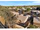 Aerial view of a backyard and the back of a house in a neighborhood with lush foliage and nearby streets at 1120 E Harbor View Dr, Gilbert, AZ 85234