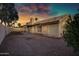 View of the home's rear exterior with a stucco finish and minimal landscaping at 1120 E Harbor View Dr, Gilbert, AZ 85234