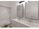 Bright bathroom featuring a double sink vanity, bathtub and toilet at 1120 E Harbor View Dr, Gilbert, AZ 85234