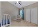 Bedroom with a ceiling fan, chair, closet and baby crib at 1120 E Harbor View Dr, Gilbert, AZ 85234