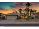 Inviting single-story home featuring desert landscaping, an attached two-car garage, and a captivating sunset at 1120 E Harbor View Dr, Gilbert, AZ 85234