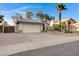 Attractive tan home with a two car garage, desert landscaping, and blue skies overhead at 1120 E Harbor View Dr, Gilbert, AZ 85234