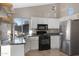 Modern kitchen with stainless refrigerator, granite counters, and white cabinets at 1120 E Harbor View Dr, Gilbert, AZ 85234