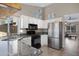 Modern kitchen with stainless steel appliances, granite countertops, and white cabinetry at 1120 E Harbor View Dr, Gilbert, AZ 85234