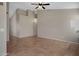 Spacious living room featuring tile flooring and a ceiling fan, perfect for comfortable living at 1120 E Harbor View Dr, Gilbert, AZ 85234