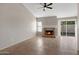 Spacious living room featuring a classic fireplace and sliding doors to the backyard at 1120 E Harbor View Dr, Gilbert, AZ 85234
