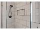 Close up of the tile work in the shower including a shower head and built in niche at 1120 E Harbor View Dr, Gilbert, AZ 85234