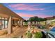 Backyard boasts a swimming pool, fire pit, outdoor kitchen, covered patio and desert landscaping at 11398 E Desert Vista Rd, Scottsdale, AZ 85255