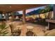 Covered patio boasts outdoor kitchen and views of a fire pit and pool at 11398 E Desert Vista Rd, Scottsdale, AZ 85255