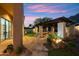 A cozy outdoor living space featuring a pergola, a fire pit, and a lush lawn at 11398 E Desert Vista Rd, Scottsdale, AZ 85255
