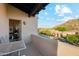 Balcony view featuring a table and chairs, desert views, and exterior of home at 11398 E Desert Vista Rd, Scottsdale, AZ 85255