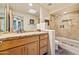 Bathroom features a stone countertop, wooden cabinets and a tile-surround shower at 11398 E Desert Vista Rd, Scottsdale, AZ 85255
