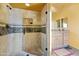Bathroom shower featuring a glass door, tiled walls, and modern fixtures at 11398 E Desert Vista Rd, Scottsdale, AZ 85255