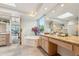 Features a bathroom vanity with natural stone counters, a large soaking tub, and bright natural lighting at 11398 E Desert Vista Rd, Scottsdale, AZ 85255