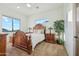 Bright bedroom featuring a decorative wooden bed frame, scenic views, and ceiling fan at 11398 E Desert Vista Rd, Scottsdale, AZ 85255