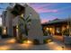 Southwestern home featuring a brick driveway, desert landscaping and a covered entryway with accent lighting at 11398 E Desert Vista Rd, Scottsdale, AZ 85255