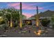 Desert-landscaped home showcasing a charming desert exterior with mature cacti and a beautiful sunset backdrop at 11398 E Desert Vista Rd, Scottsdale, AZ 85255