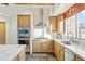 The kitchen offers modern appliances, wood cabinets, and stone countertops for a chef-inspired cooking experience at 11398 E Desert Vista Rd, Scottsdale, AZ 85255