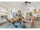 Bright living room with stone fireplace, tile floors, and large windows that bring in natural light and views at 11398 E Desert Vista Rd, Scottsdale, AZ 85255