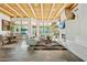 Bright living room features a decorative fireplace, beamed ceilings, and tile floors leading to an outdoor area at 11398 E Desert Vista Rd, Scottsdale, AZ 85255