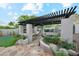 Outdoor kitchen and bar area with stone counters and an integrated grill at 11398 E Desert Vista Rd, Scottsdale, AZ 85255