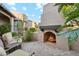 Private outdoor patio boasting a fireplace, brick flooring, and lush foliage perfect for outdoor entertaining at 11398 E Desert Vista Rd, Scottsdale, AZ 85255