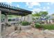 Backyard features a pool, outdoor kitchen and rock landscaping at 11398 E Desert Vista Rd, Scottsdale, AZ 85255