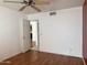 Bright bedroom with hardwood floors, a ceiling fan, and an open doorway for easy access at 11403 W Rosewood Dr, Avondale, AZ 85392