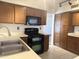 Functional kitchen boasts wooden cabinets, black appliances, tile flooring, and bright overhead lighting at 11403 W Rosewood Dr, Avondale, AZ 85392