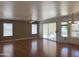 Bright living room featuring hardwood floors, a ceiling fan, and sliding glass doors to the outdoor space at 11403 W Rosewood Dr, Avondale, AZ 85392
