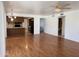 Open-concept living room showcases hardwood floors, a ceiling fan, and seamless transition to the kitchen at 11403 W Rosewood Dr, Avondale, AZ 85392