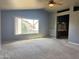 Carpeted living room with modern accents, a ceiling fan, and a window view of the neighborhood at 11403 W Rosewood Dr, Avondale, AZ 85392