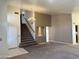 Spacious living area with neutral carpet, a chandelier, and a staircase leading to the upper level at 11403 W Rosewood Dr, Avondale, AZ 85392