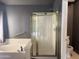 Bathroom features a soaking tub and a separate shower with gold trim at 11403 W Rosewood Dr, Avondale, AZ 85392
