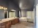 Spacious bathroom features a double vanity, a soaking tub, and a separate shower at 11403 W Rosewood Dr, Avondale, AZ 85392