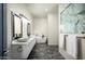 Elegant bathroom featuring a double sink vanity, a soaking tub, and a frameless shower with marble-style tiling at 11426 E Quail Ln, Cave Creek, AZ 85331
