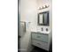 Bathroom with vanity featuring framed mirror, a stylish sink, and modern fixtures, ideal for guests at 11426 E Quail Ln, Cave Creek, AZ 85331