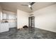 Stylish bedroom with a ceiling fan, and adjacent kitchen area, offering comfort and convenience at 11426 E Quail Ln, Cave Creek, AZ 85331