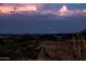 Breathtaking panoramic view showcasing a city skyline illuminated at night, with vibrant clouds above at 11426 E Quail Ln, Cave Creek, AZ 85331