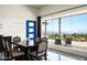Dining room features a large picture window showcasing breathtaking outdoor views and a stylish blue door at 11426 E Quail Ln, Cave Creek, AZ 85331