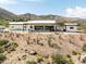 Contemporary home with a flat roof, desert landscaping and mountain views at 11426 E Quail Ln, Cave Creek, AZ 85331