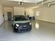 Bright, spacious garage with epoxy flooring, car, and ample room for storage and parking at 11426 E Quail Ln, Cave Creek, AZ 85331