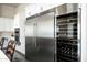 Modern kitchen equipped with stainless steel appliances including a refrigerator, wine cooler, and built-in oven at 11426 E Quail Ln, Cave Creek, AZ 85331