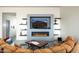Cozy living room with modern fireplace, built-in shelving, and comfortable seating, ideal for relaxation at 11426 E Quail Ln, Cave Creek, AZ 85331