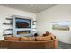 Bright living room featuring a cozy sofa, fireplace, mountain views, and sleek modern shelving at 11426 E Quail Ln, Cave Creek, AZ 85331