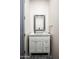 Chic powder room featuring a decorative mirror, elegant vanity, and stylish fixtures at 11426 E Quail Ln, Cave Creek, AZ 85331