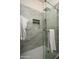 Modern shower with gray tiling, built-in niche, and a frameless glass door providing a sleek and luxurious experience at 11426 E Quail Ln, Cave Creek, AZ 85331